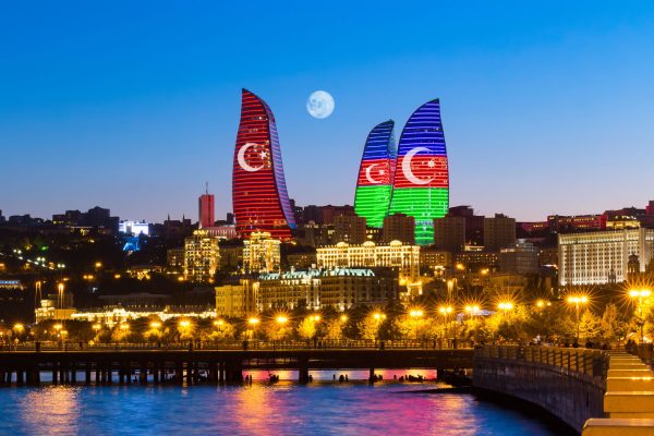 Baku, Azerbaijan - September 22, 2020: Flame Towers in the colors of the flag of Turkey and Azerbaijan - original neon lighting. State symbols of the Turkish and Azerbaijan Republics